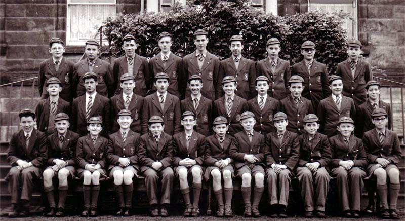 Class Photo .jpg - Back row: 1. David Wright, 2. Paul Martin, 3. Jimmy Hunt, 4.Mike Ashley, 5.(Fr) Tom Flynn, 6.Jock McLaughlin, 7.Steve MacDonald, 8. Terry Egan, 9. Billy Gillan Middle row: 1. Joe Barrett, 2. David Lamberty, 3.Michael McNamara, 4. Malcolm Tunmore, 5. Brendan McCann 6. Chris Barry 7. James Moran 8. Michael Bergin, 9. John Broadley, 10. John McKenna Front row: 1.Steve McQueenie, 2.James Murdoch, 3. John Neville, 4. Leo Cunning, 5. Andrew Lonie, 6.Derek Marshall, 7. Frank Malcolm, 8. James Clark, 9. Patrick Burke, 10. Bruce Laidlaw, 11. Frank Jordan, 12. Michael Gillard. About 1955.(Additional names added David Wright, thanks.)